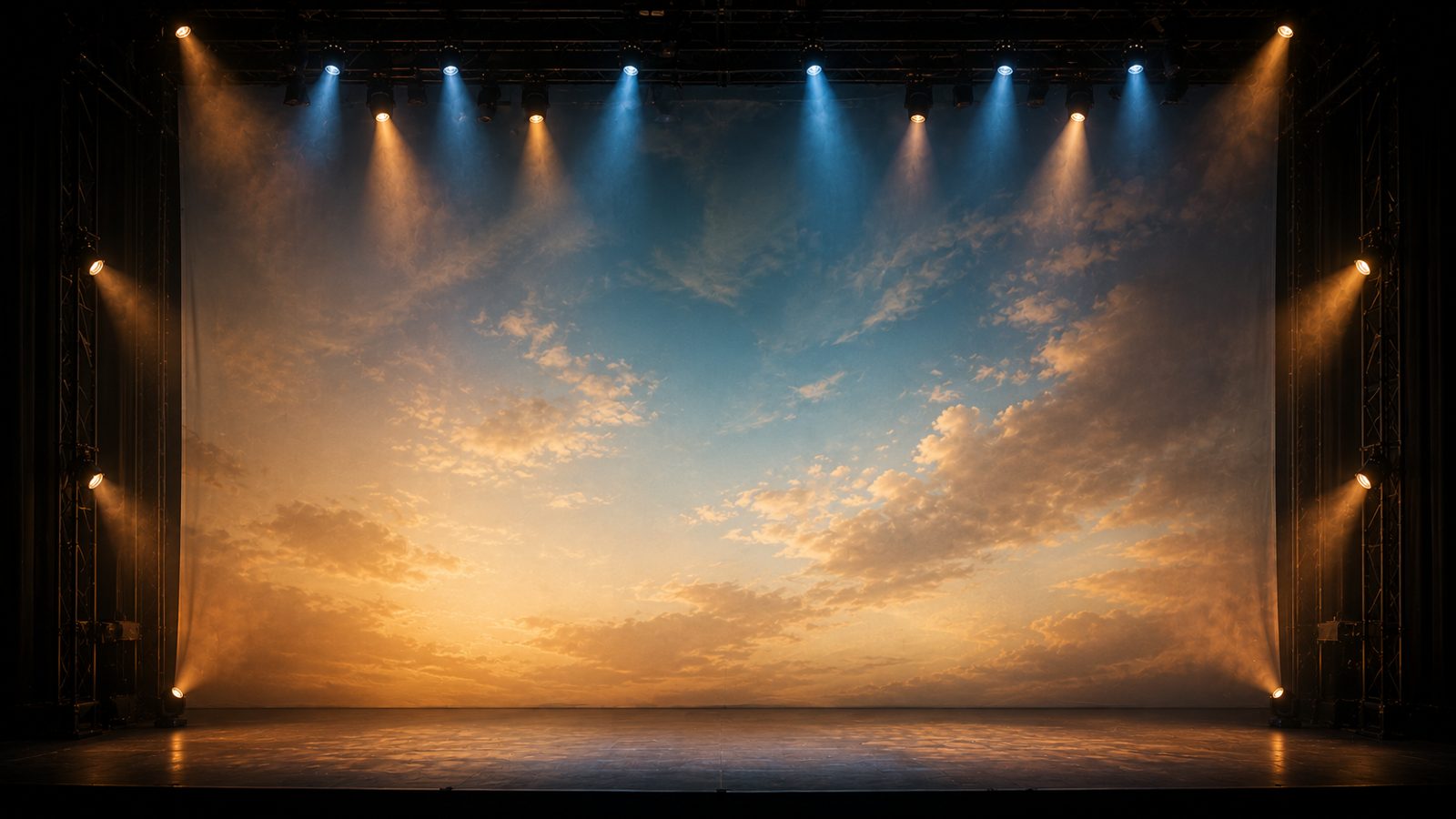 Large printed cyclorama backdrop stretched across the rear of a stage with a full-color sky scene